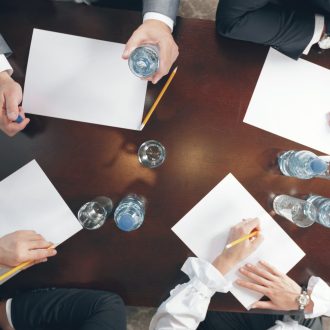 Group of busy business people working in office, top view